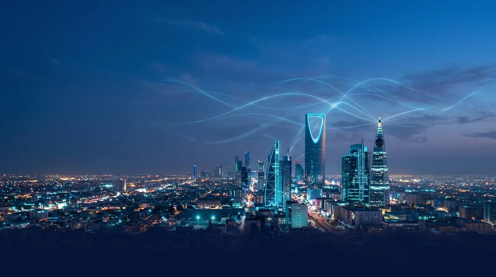 The Riyadh skyline at night, currents of light arcing across the city